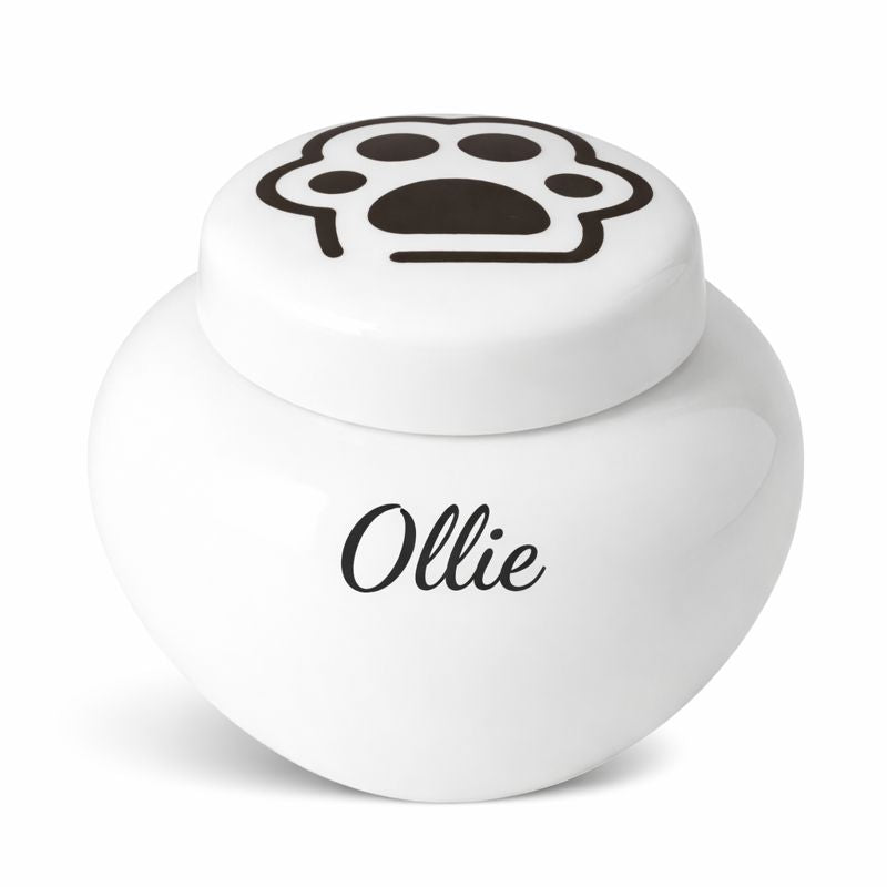 Witte keramische kattenurn met zwarte pootafdruk op het deksel