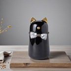 Urn voor kat - gemaakt van zwart keramiek, met goudkleurige details en is voorzien van een schattig strikje